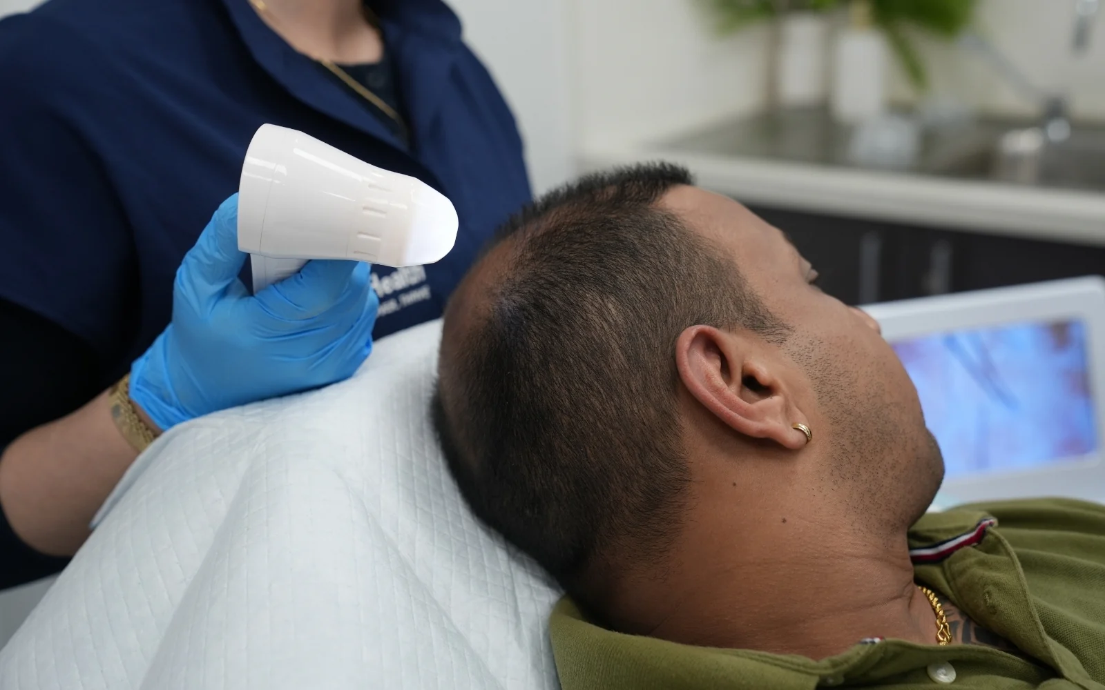 Practitioner examining the scalp during a hair and scalp assessment
